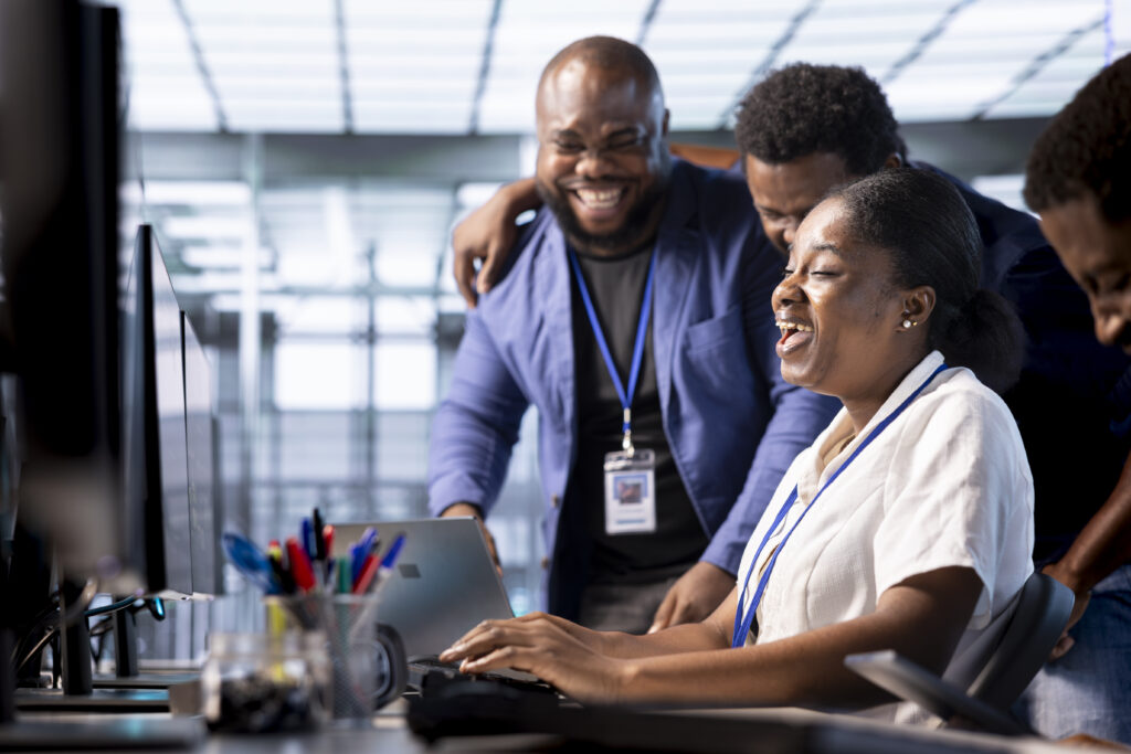 team of happy engineers laughing in data center office
